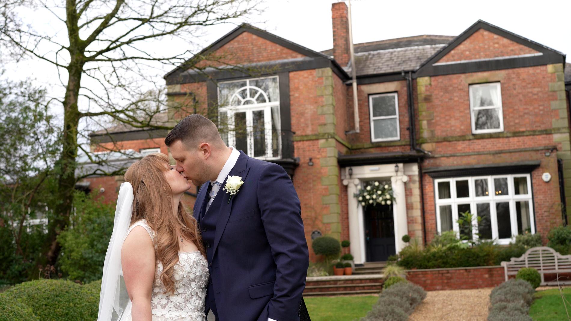 a couple kiss outside Ashfield House Standish near Wigan