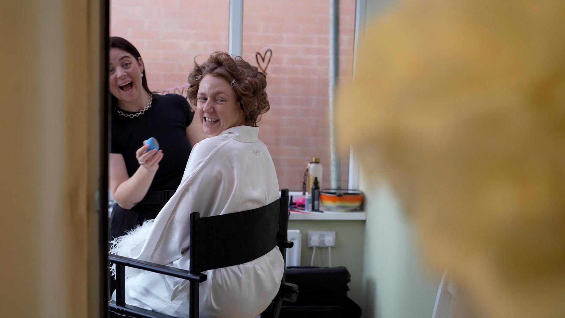 a bride and MUA react to the stunning wedding bouquet by rose boutique wigan