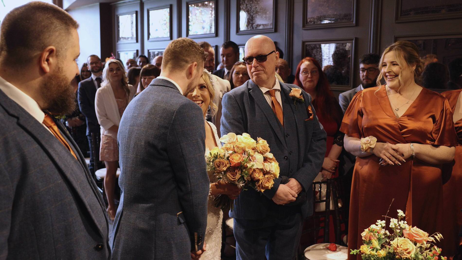 a video still of a first look at the wedding ceremony at Manor House Lindley