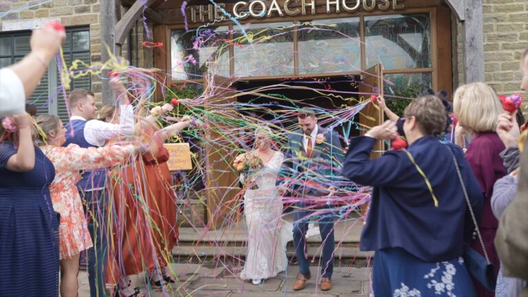 video still of a couple getting showered in rainbow streamers