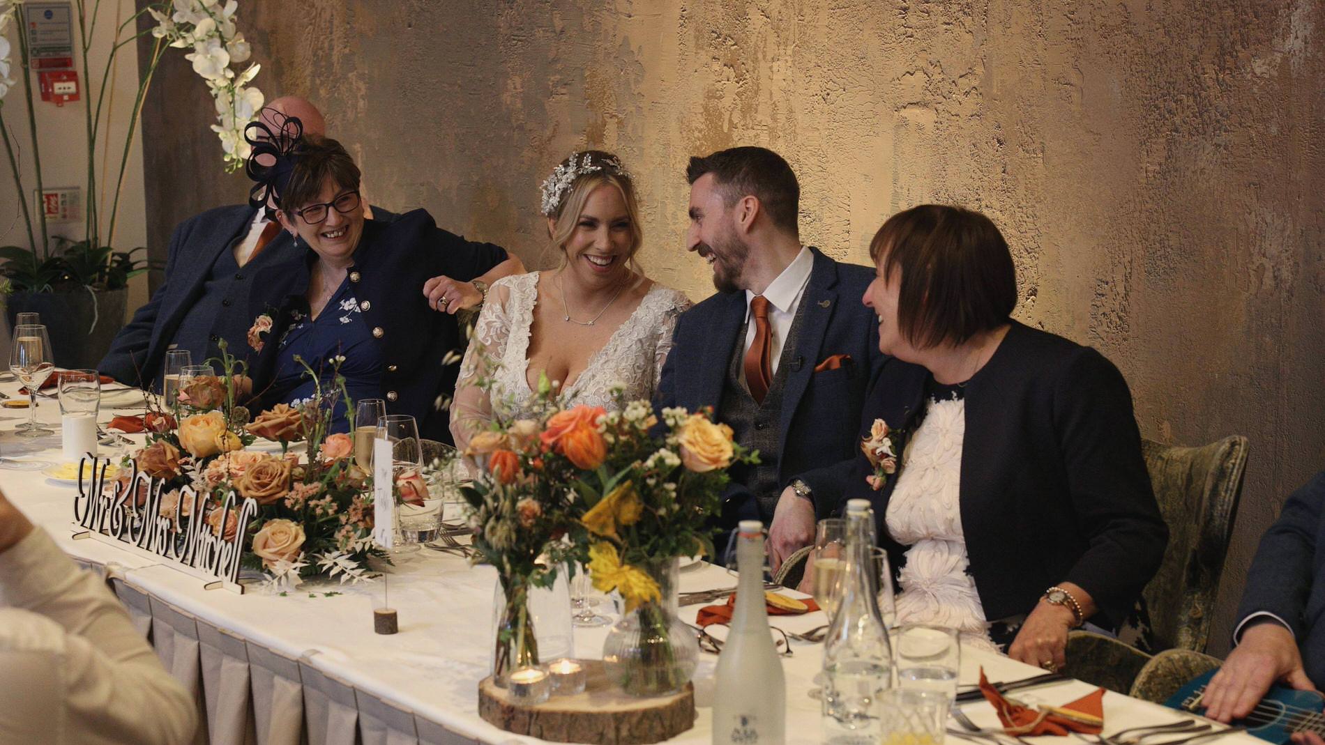 the couple laugh with each other during the bridesmaid speech at Manor House Lindley