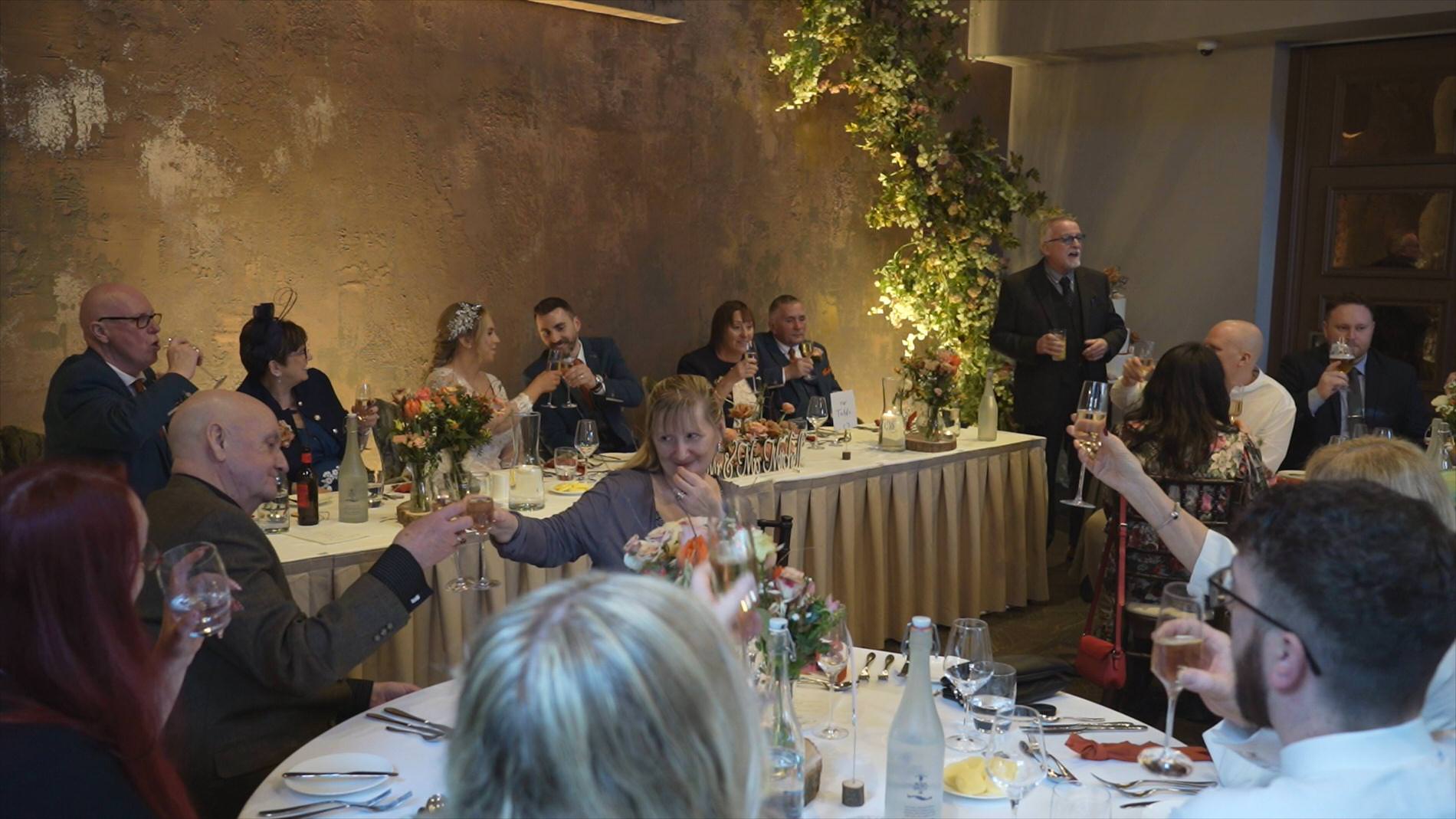 guests toast the couple at the end of the wedding speeches