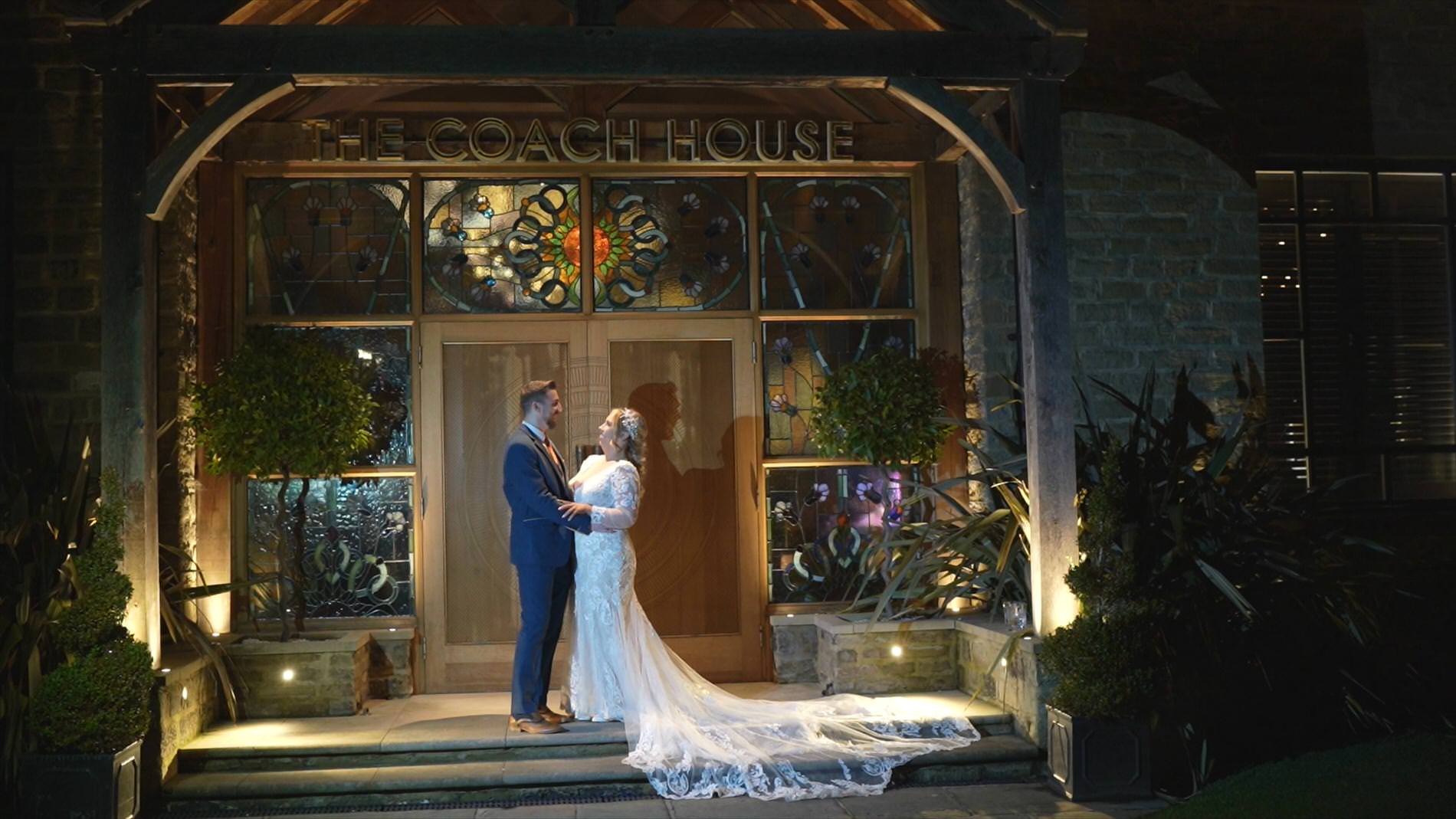 a couple pose outside the Coach House during a winter wedding at Manor House Lindley