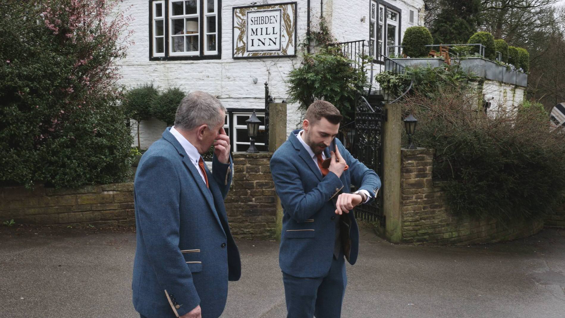 a groom looks at his watch outside Shidben Mill