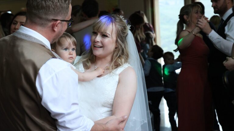 the couple enjoy their first dance with their daughter at The Saddleworth Hotel