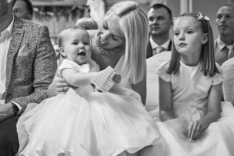 a natural black and white photo of mum and daughter smiling during naming day ceremony in UpHolland