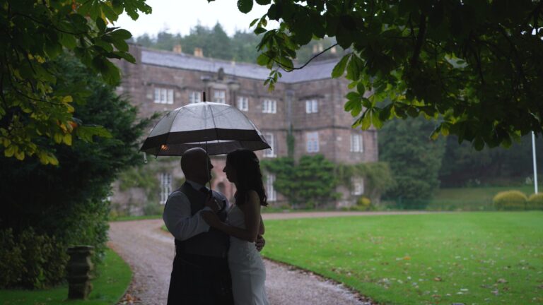 a beautiful candid moment caught on video outside Browsholme Hall in the pouring rain