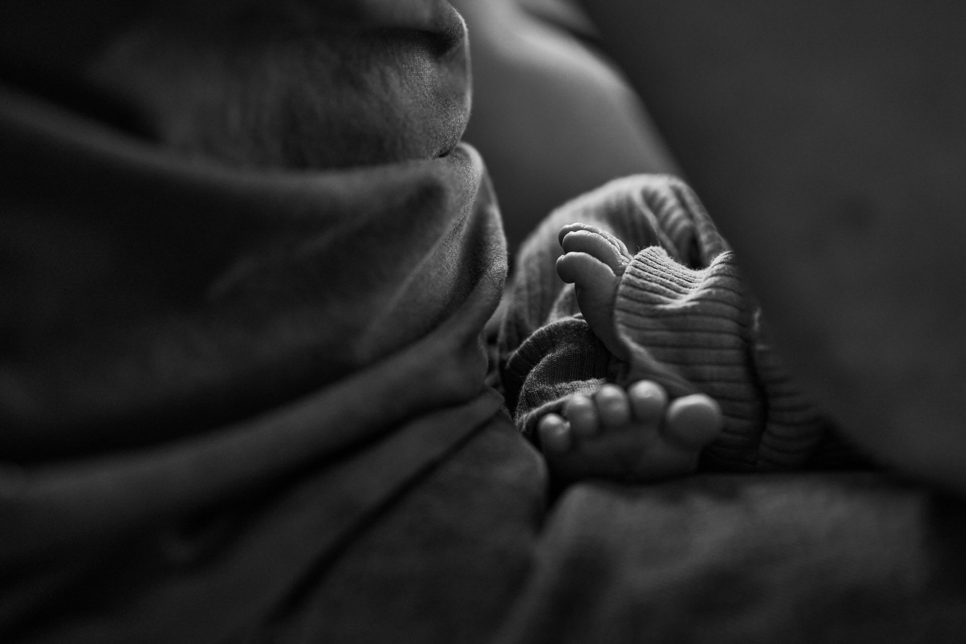 a close up photo of a babys feet on dads lap