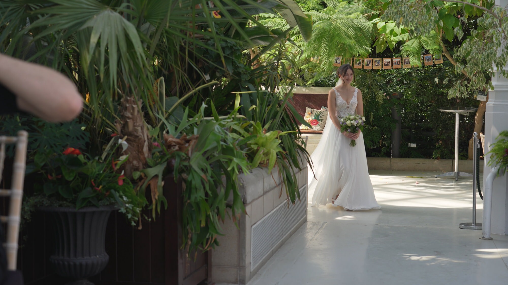 Kirsty and Josh Sefton Palm House Wedding Video 11 a bride makes her solo walk down the aisle at Sefton Park Palm House