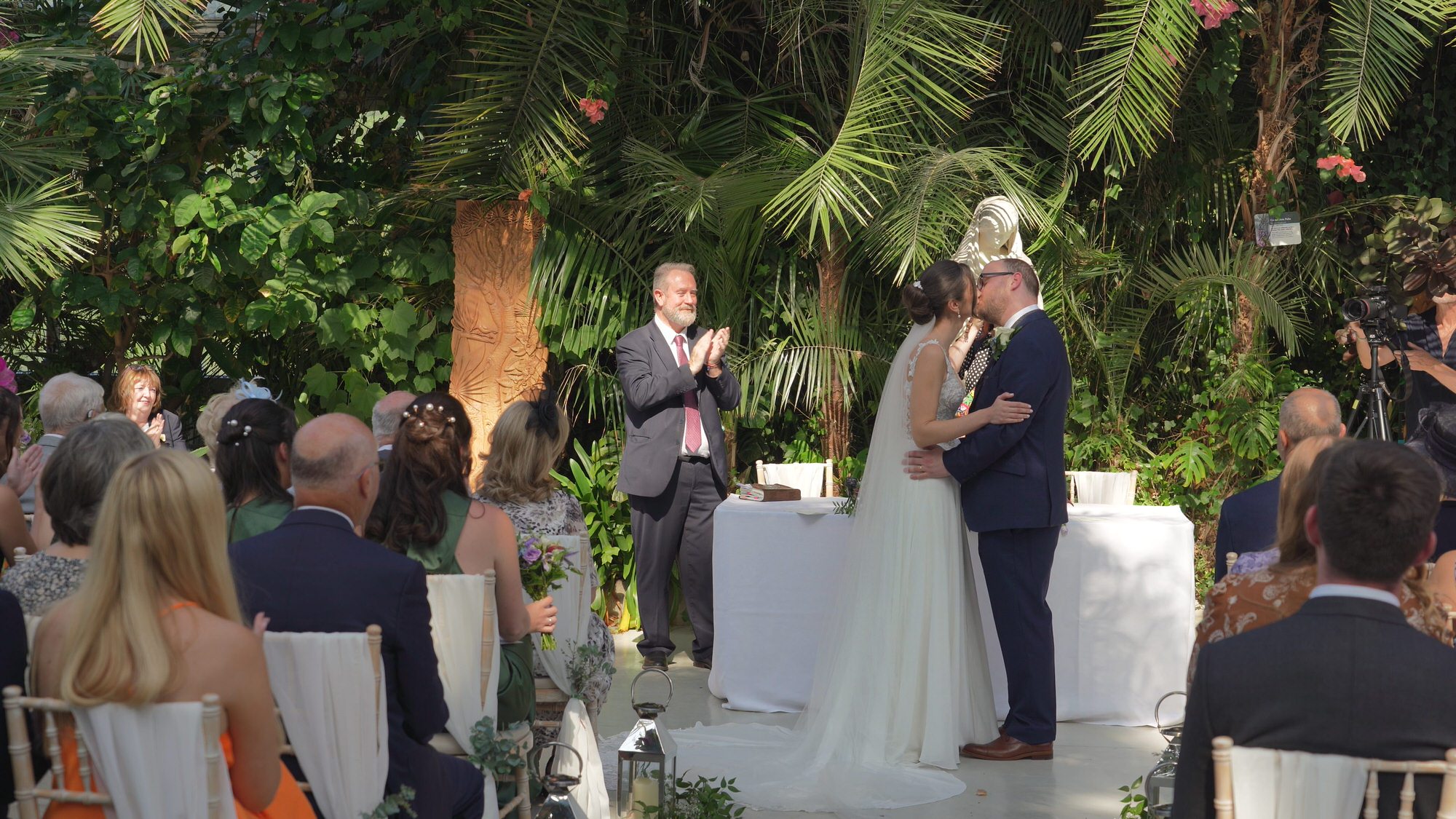 Kirsty and Josh Sefton Palm House Wedding Video 16 a couple kiss during ceremony at Sefton Park Palm House