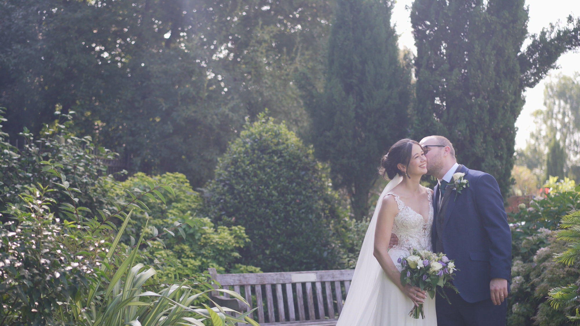 Kirsty and Josh Sefton Palm House Wedding Video 24 a couple chat and laugh during couple photos and video outside Sefton Palm House