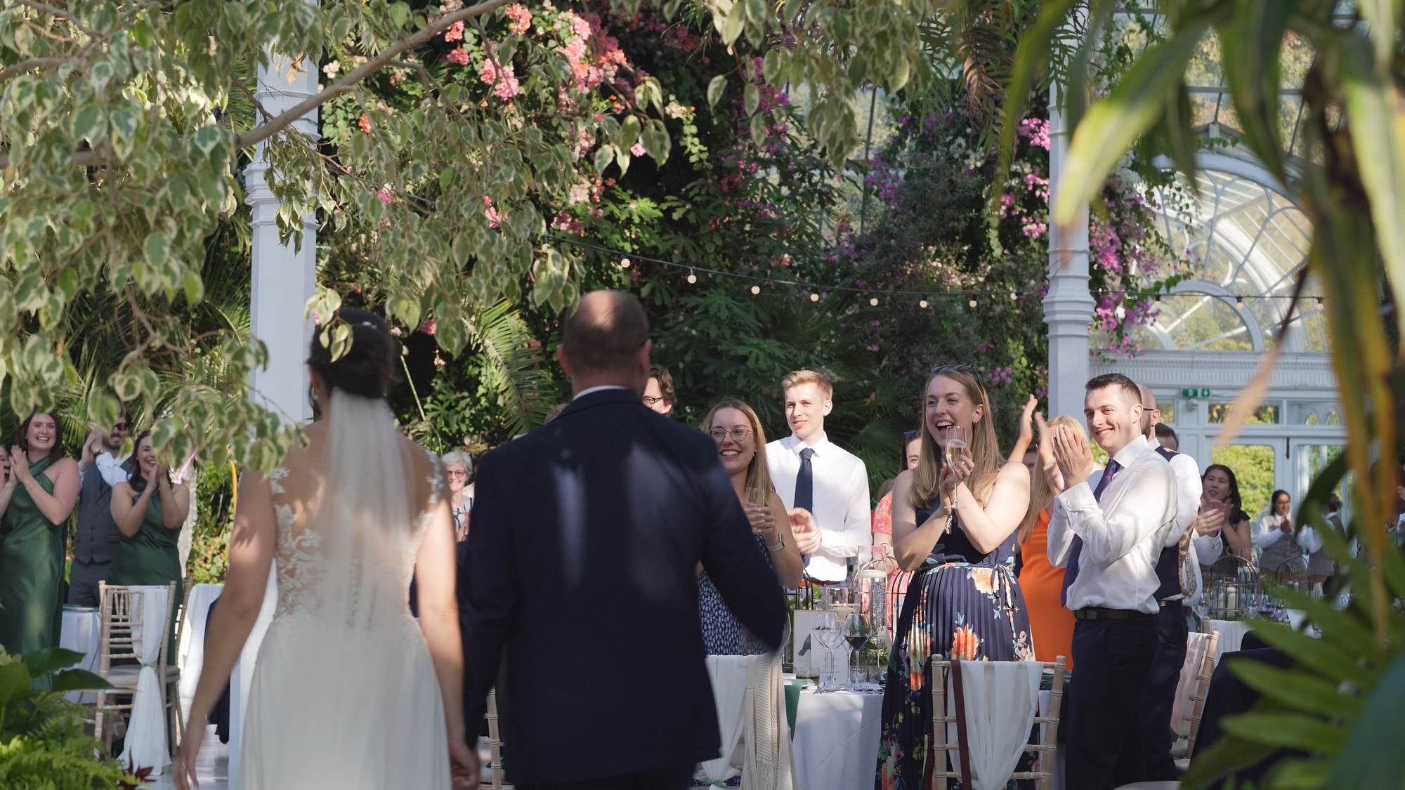 Kirsty and Josh Sefton Palm House Wedding Video 26 a couple walk in to their wedding breakfast at Sefton Park Palm House Liverpool