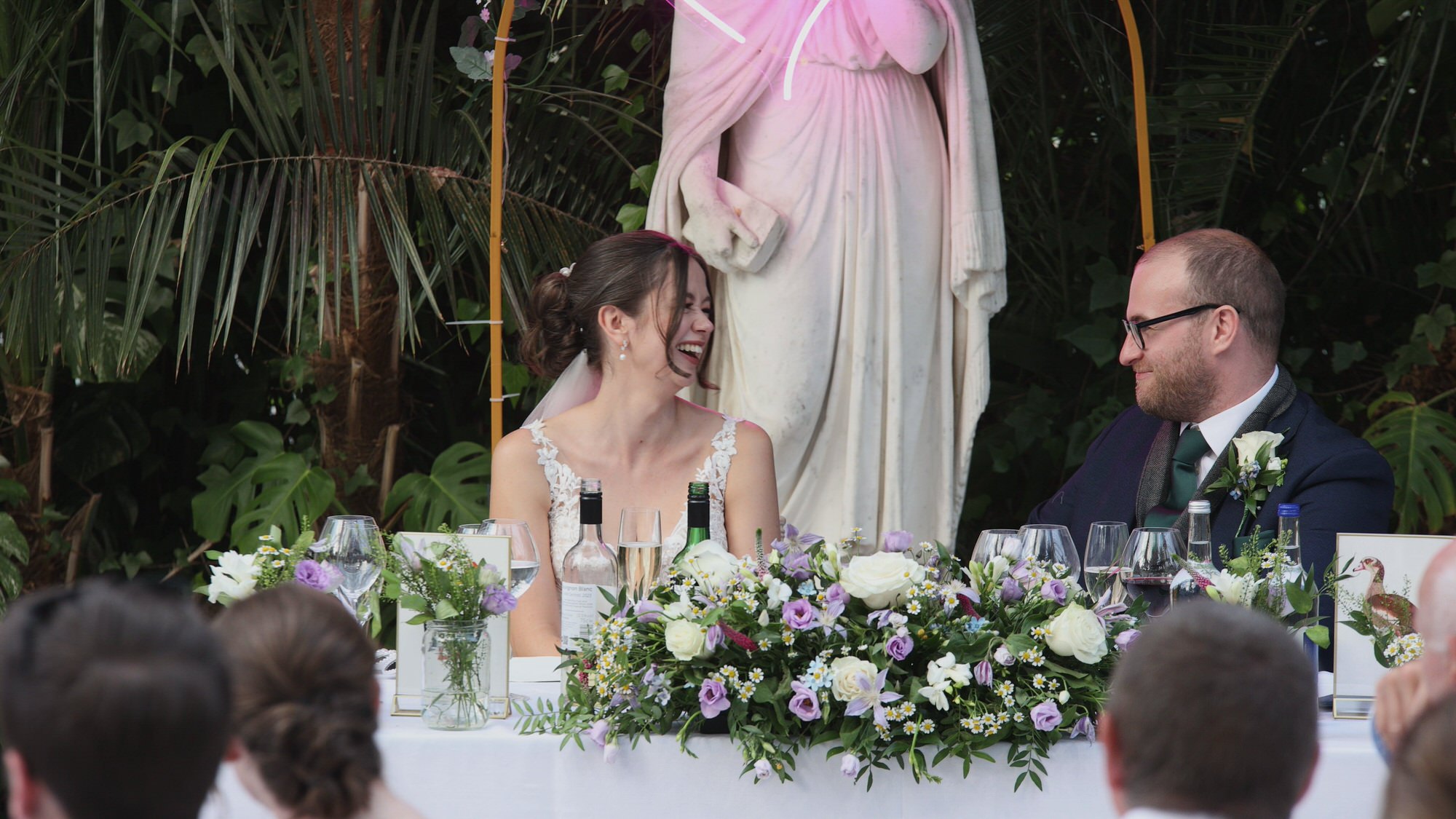 Kirsty and Josh Sefton Palm House Wedding Video 27 the couple laugh during a mother of the bride speech at Sefton Park Palm House Liverpool