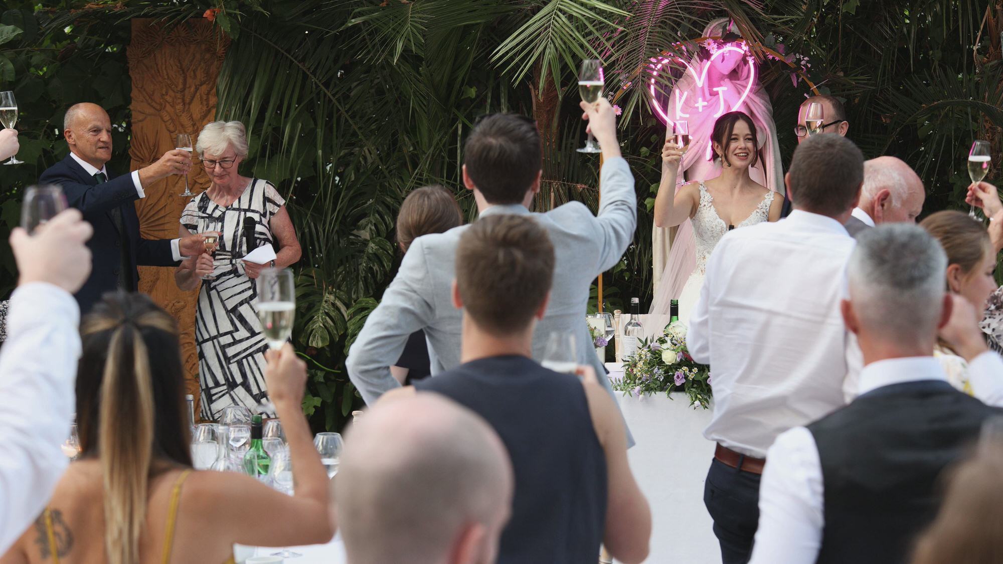Kirsty and Josh Sefton Palm House Wedding Video 28 a wide shot of wedding toasts at Sefton Park Palm House Liverpool