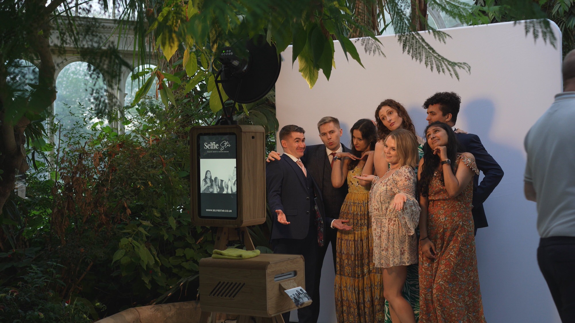 Kirsty and Josh Sefton Palm House Wedding Video 32 guests cuddle in for a fun photobooth at Sefton Park Palm House Liverpool