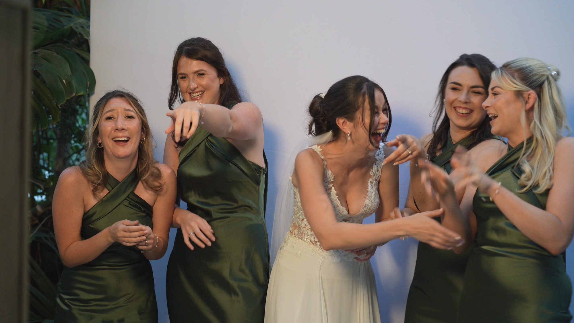 Kirsty and Josh Sefton Palm House Wedding Video 33 a bride laughs with her bridemaids at a silly photobooth photo