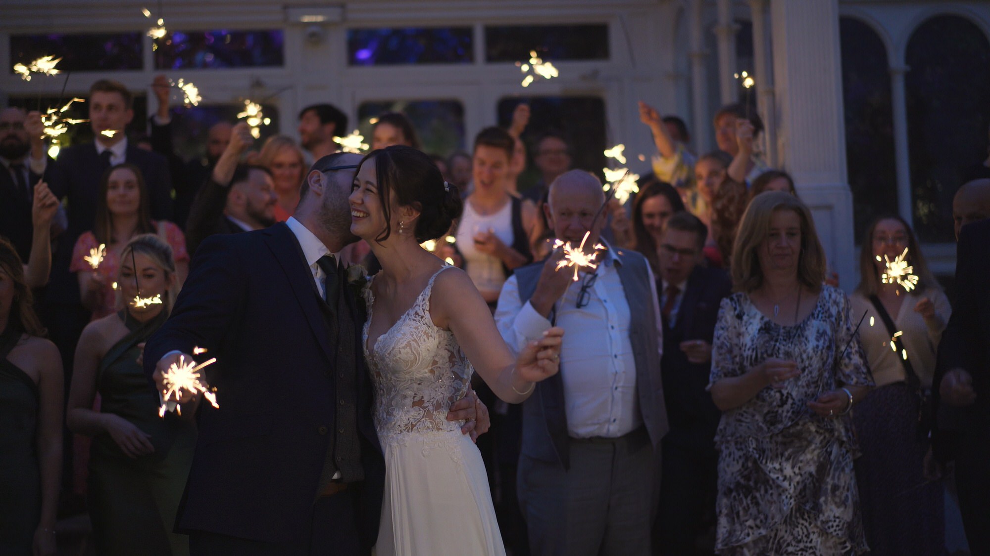 Kirsty and Josh Sefton Palm House Wedding Video 36 guests laugh during confetti shot outside Sefton Park Palm House Liverpool