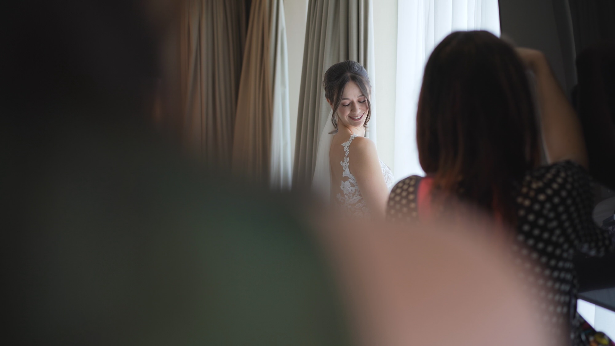 Kirsty and Josh Sefton Palm House Wedding Video 7 a natural video still capturing a bride posing for her wedding photographer at The Hilton Liverpool