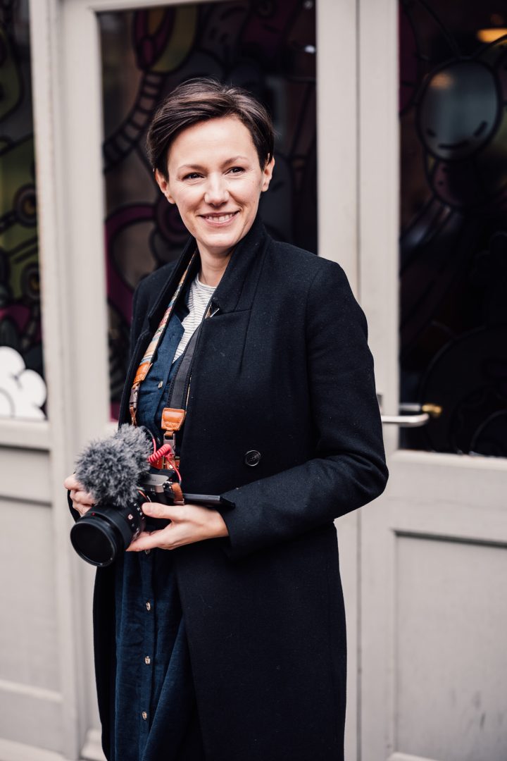 female wedding videographer posing with sony camera