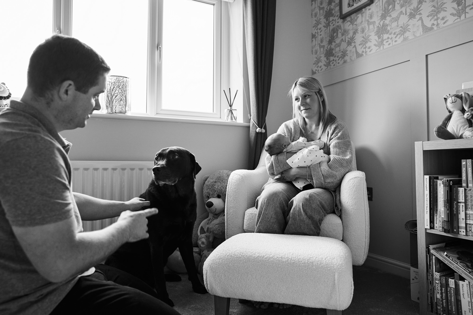 a relaxed documentary family photo of a family at home with a newborn