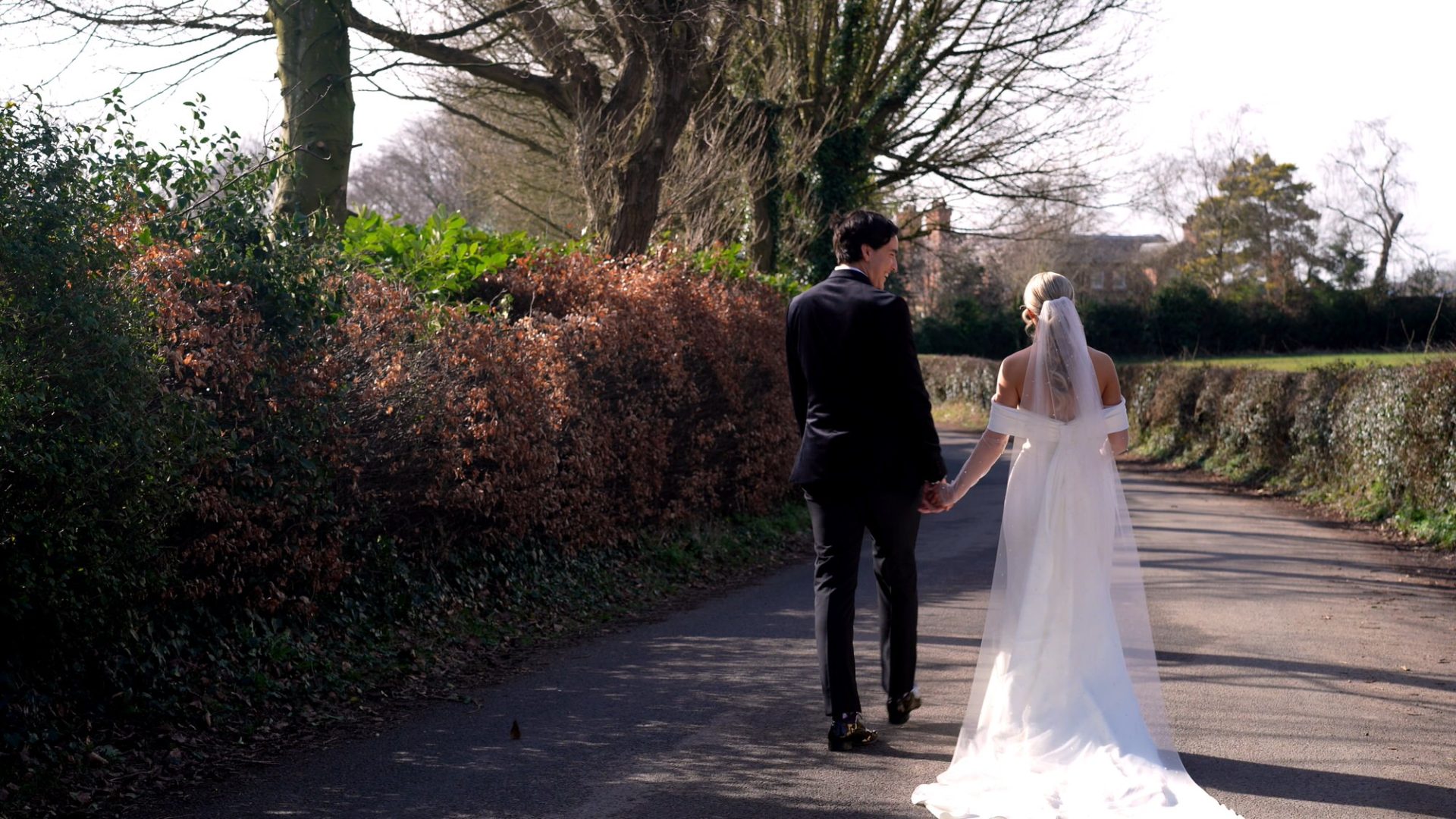 a couple walk down a country lane near Larkspur Lodge in Knutsford