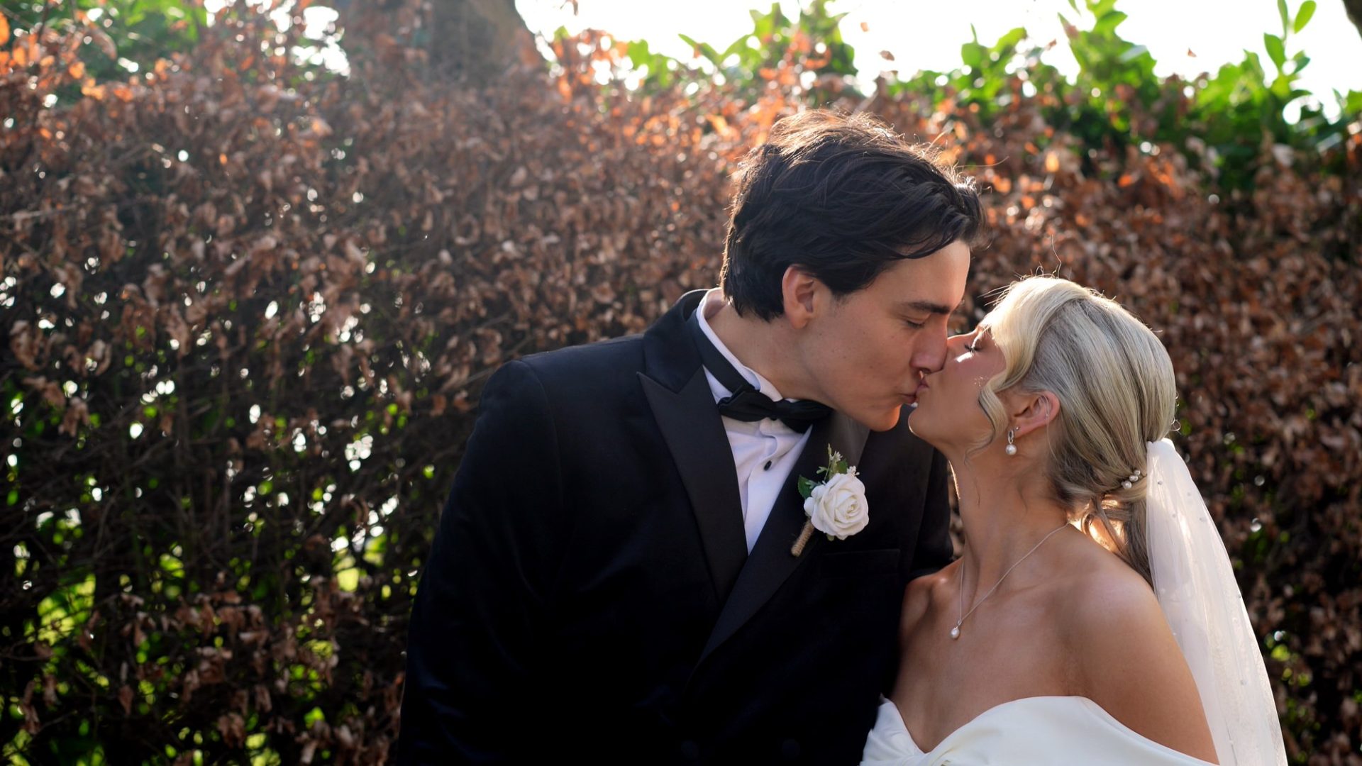 the couple kiss during photos and video at Larkspur Lodge in Cheshire