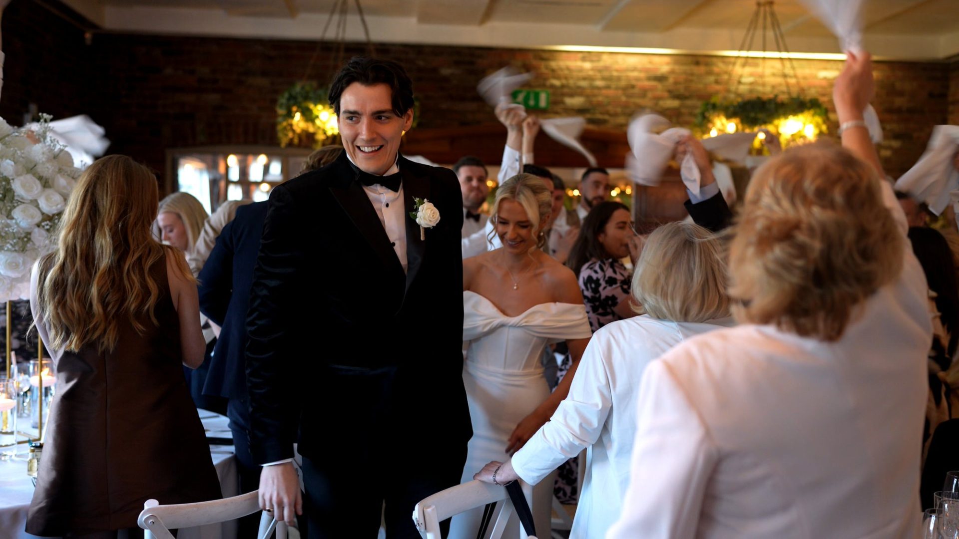a couple smile whilst being announced into the reception room at Larkspur Lodge in Cheshire