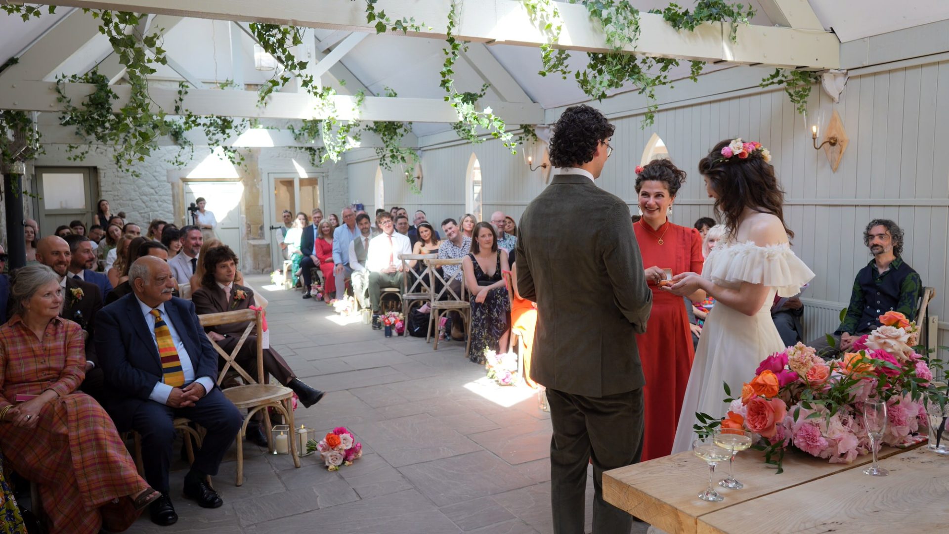 the grooms sister hands over the wedding rings