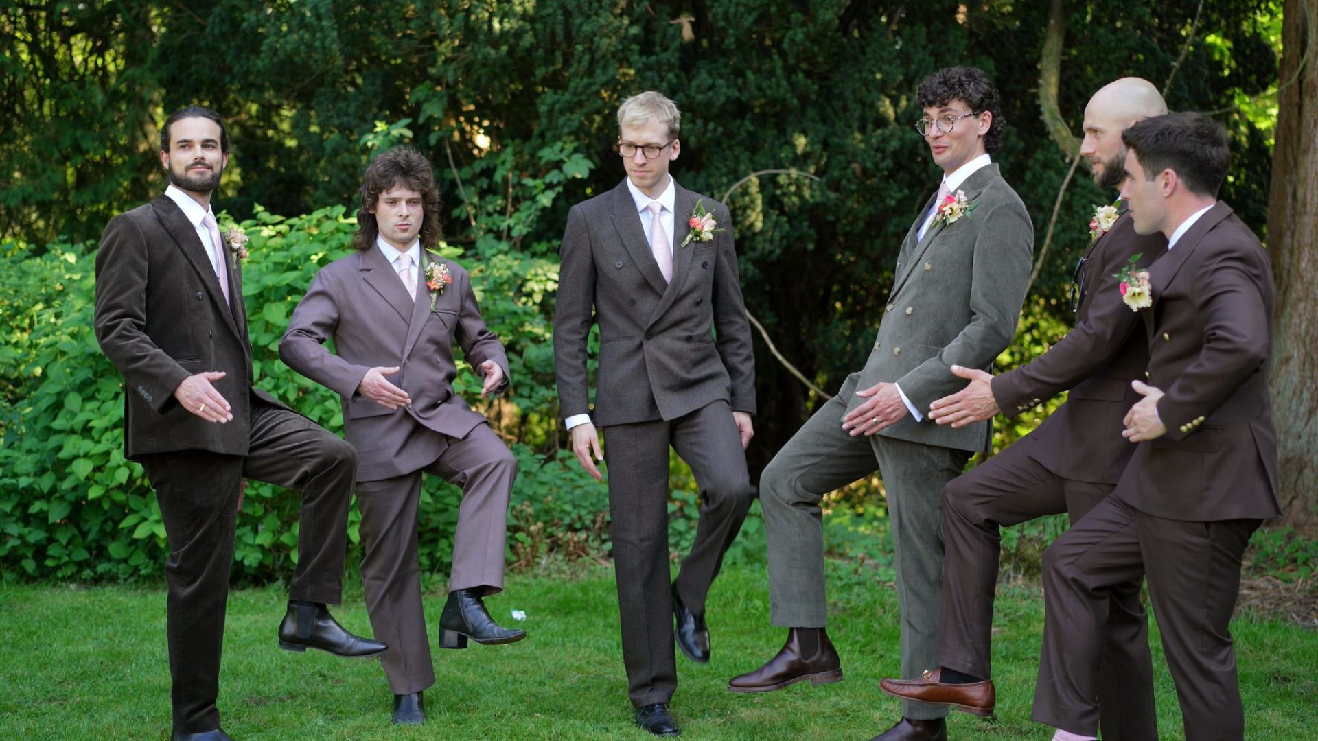 the groomsmen try posing for their wedding photos