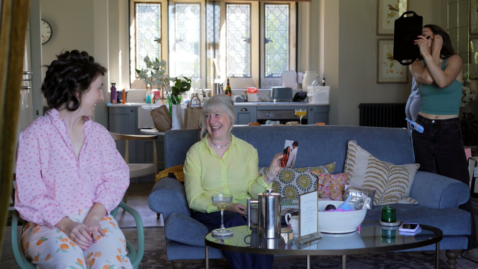 a mother of the bride laughs with her daughter in the kitchen at Wyresdale Park