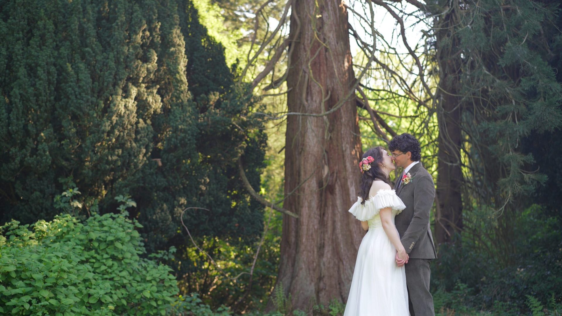 a couple kiss by an ancient forest of bowland tree at Wyresdale Park