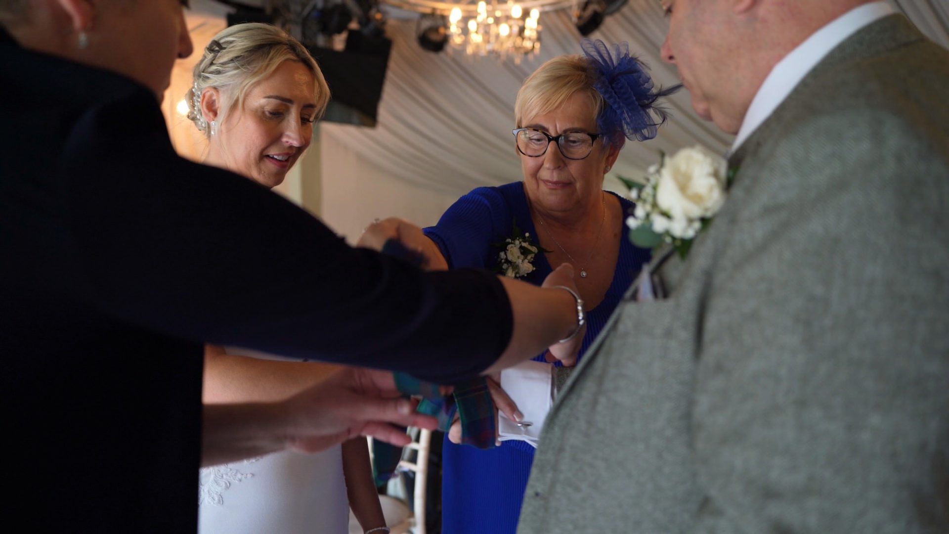 a videographer captures a hand fasting ceremony