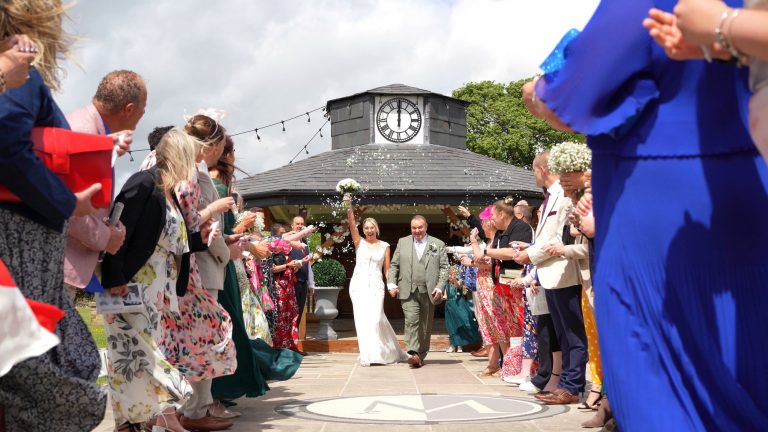 a fun video still of the couple walking down the confetti aisle outside The Moorlands Inn Halifax