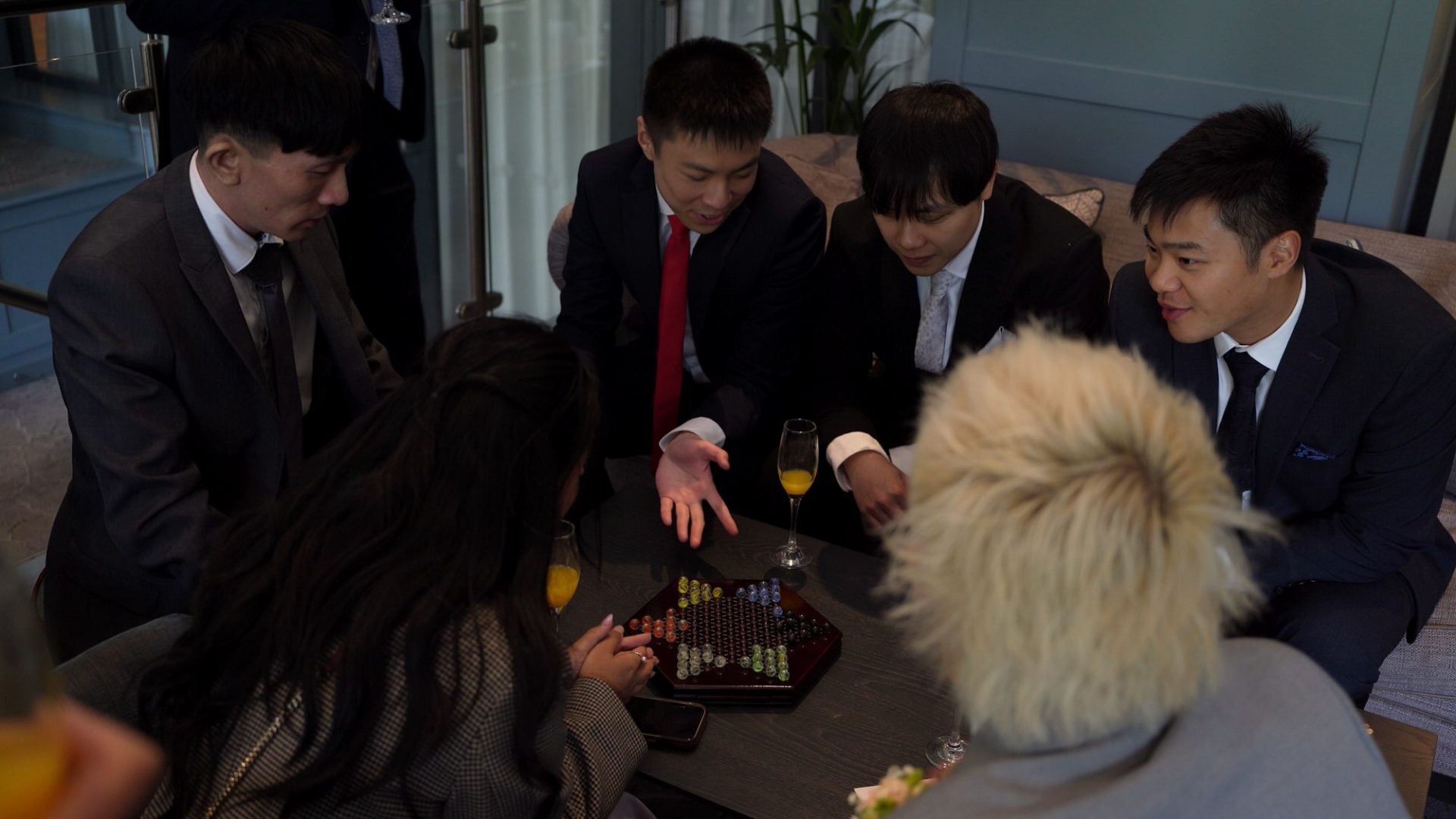 guests enjoy traditional chinese board games during the wedding reception