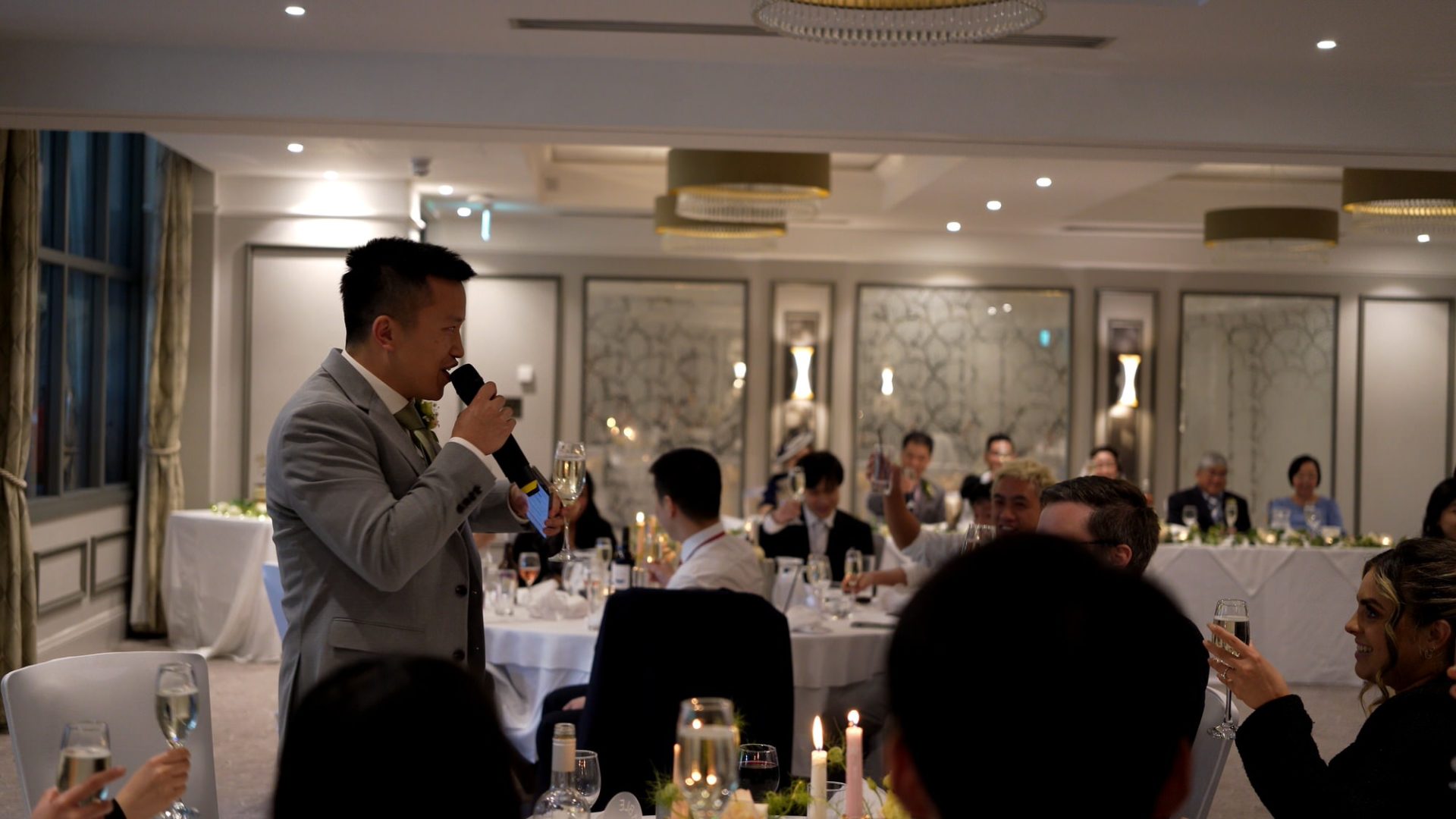 a best man toasts the bride and groom during his speech