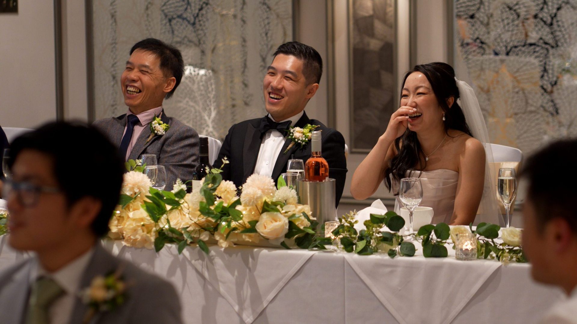 the couple laugh from the top table during their reception at Lodore Falls