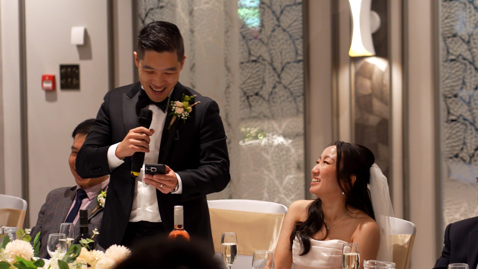 the groom makes the bride smile during his speech at Lodore Falls