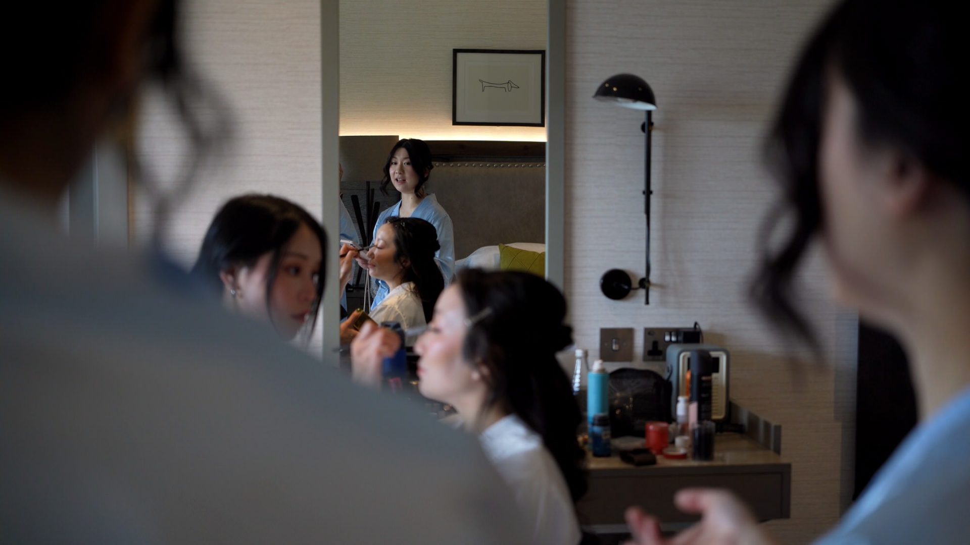 an asian makeup artist with a bride and bridesmaids at lodore falls hotel