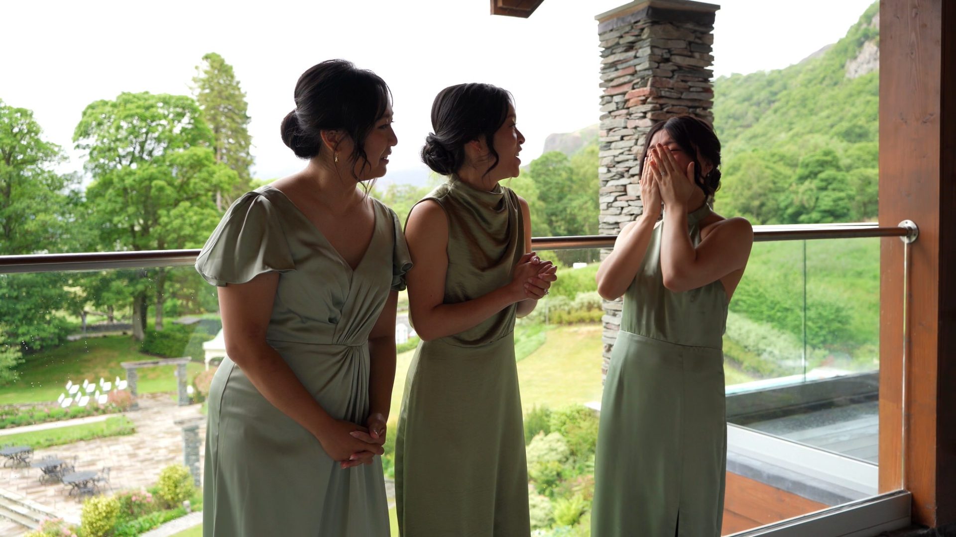 a video still of bridesmaids reacting to bride in her dress