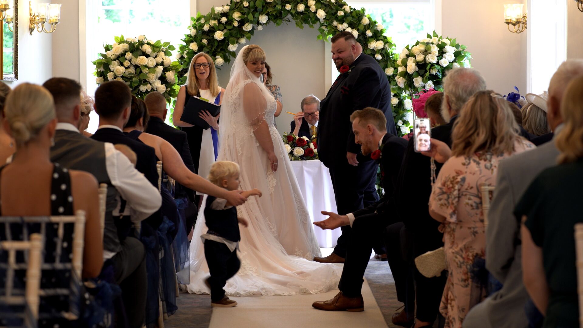 a page boy gets up to deliver the rings with the best man