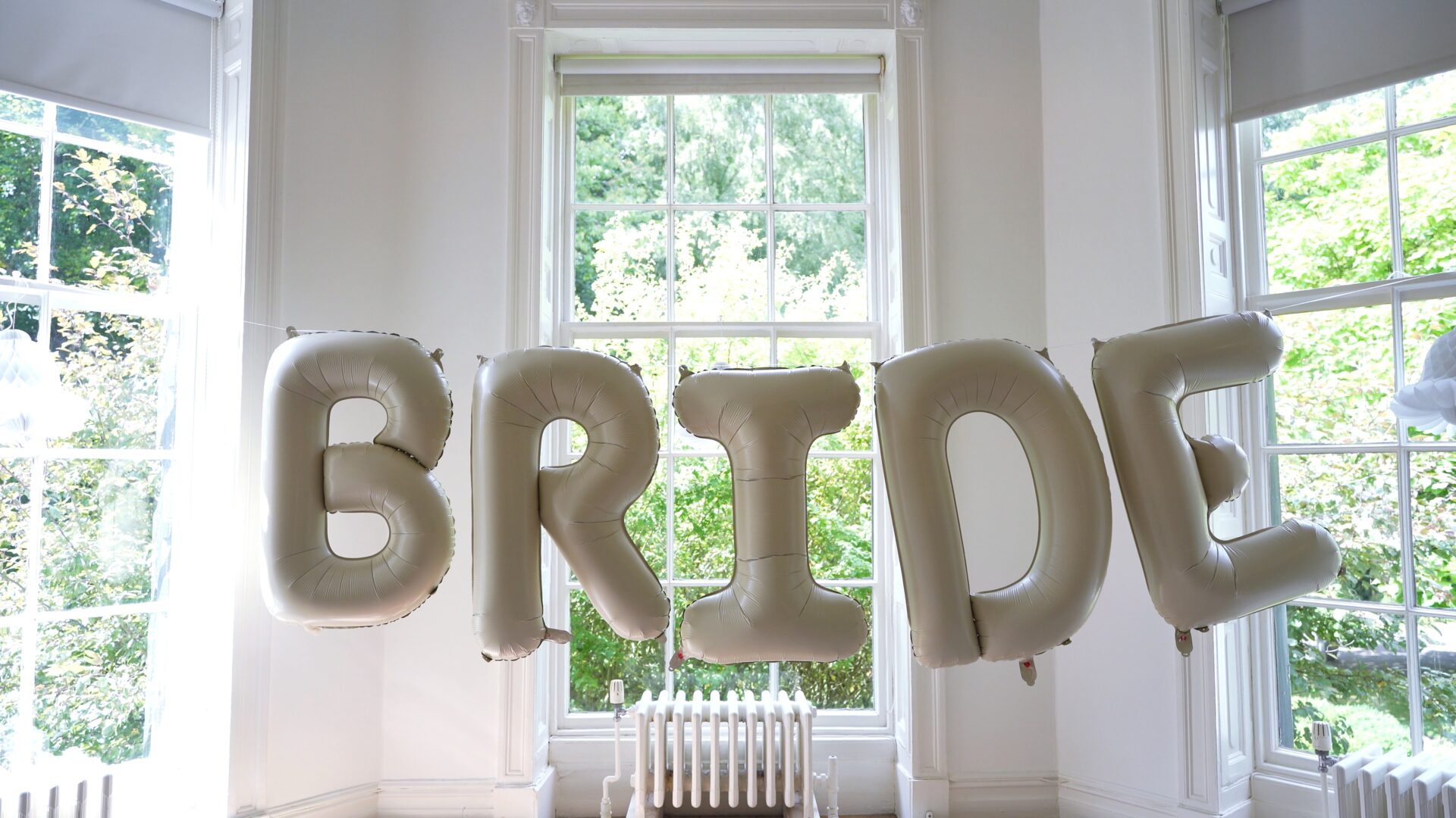 A fun bride balloon sign hangs in the dressing room at Statham Lodge Hotel in Cheshire