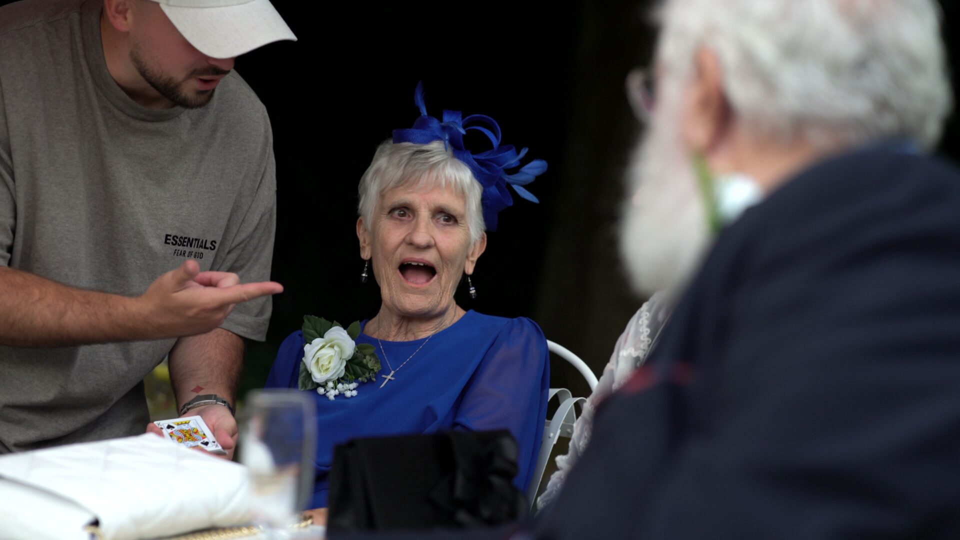 a female guest is wowed by a magician at a wedding at Statham Lodge Hotel in Cheshire