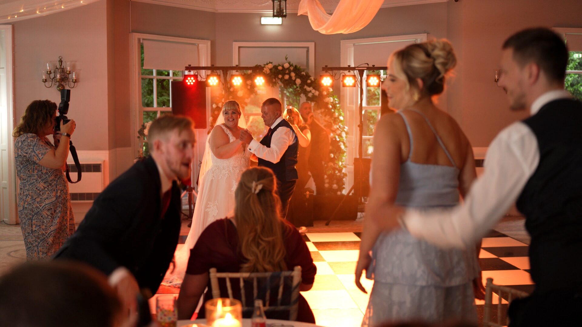 a bride laughs with her dad during dancing at Statham Lodge Hotel reception