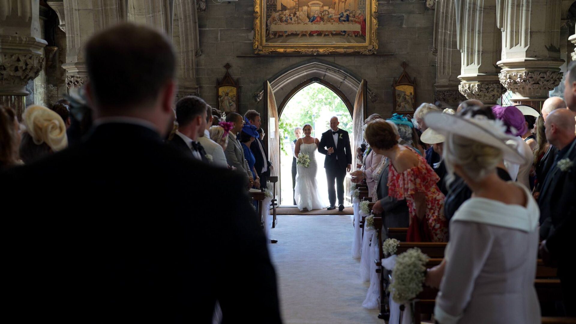 a video still of a bride entering the 19th century chapel at Rudding Park Harrogate