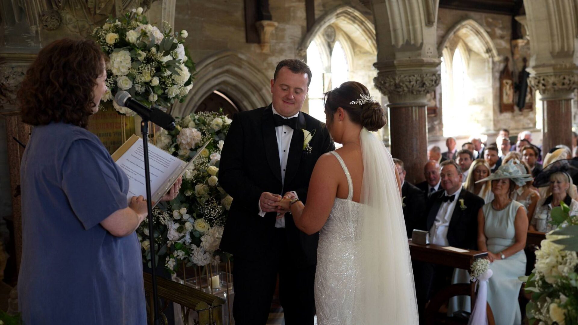 a celebrant leads the ring ceremony during a wedding at Rudding Park Harrogate