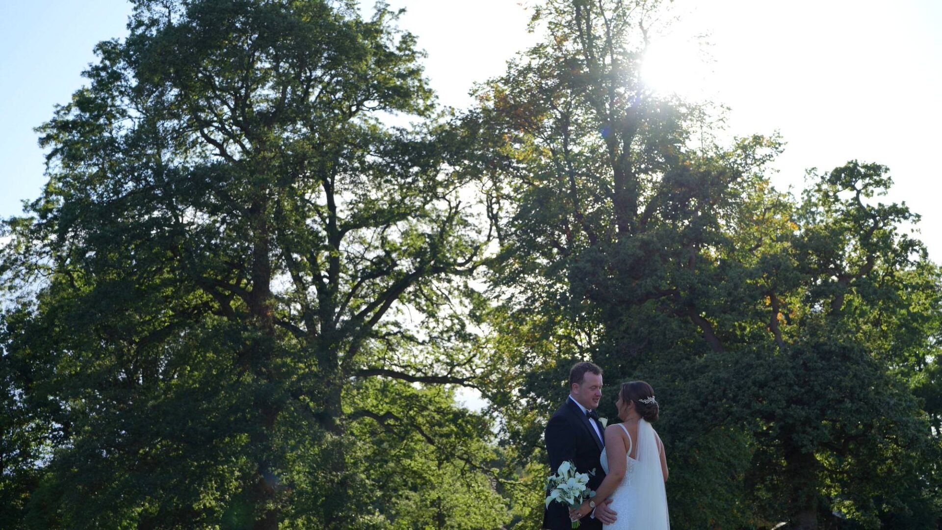 the couple take a moment in the gardens of Rudding Park Harrogate