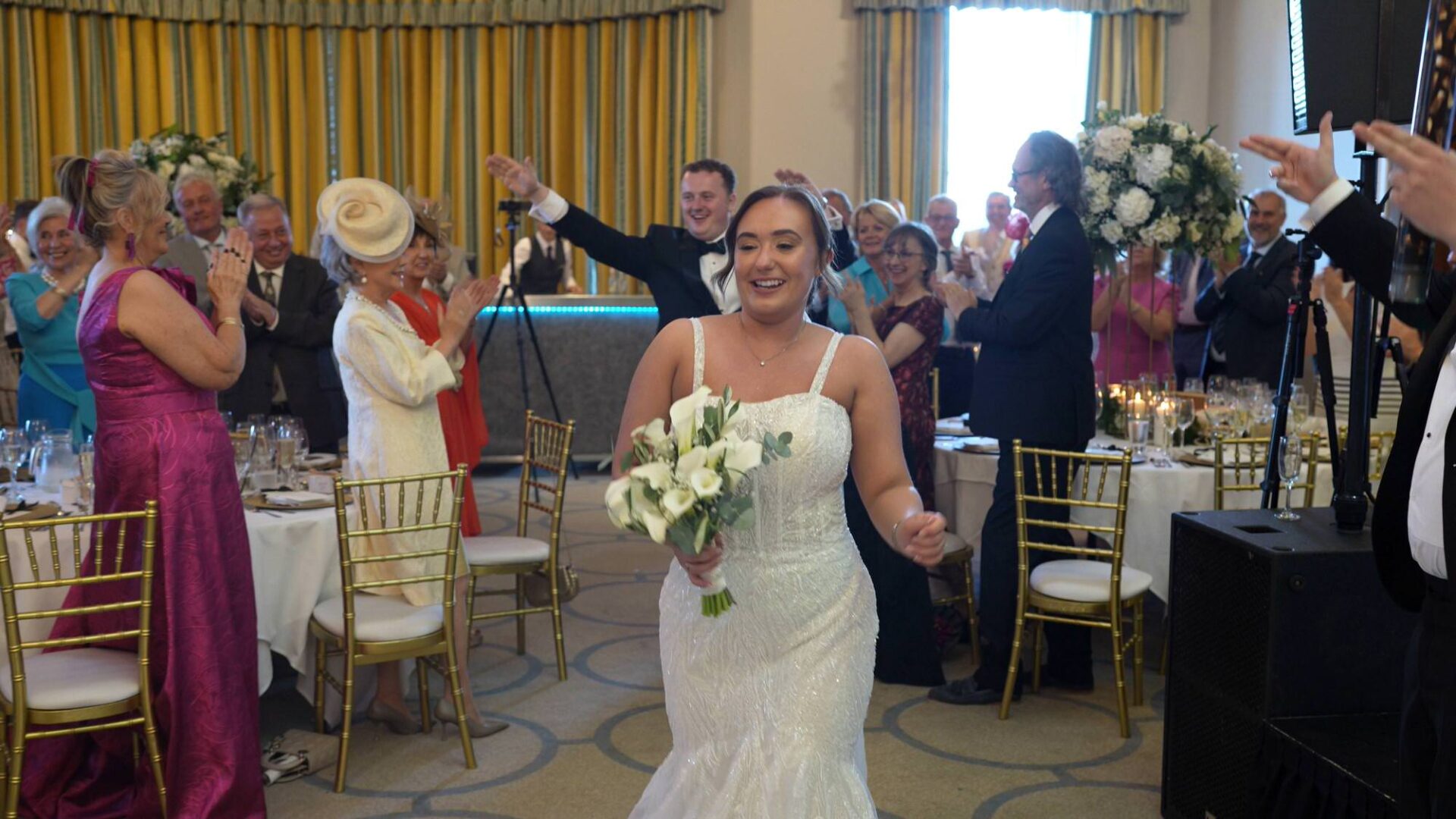 a couple are announced into the wedding breakfast to cheers at Rudding Park Harrogate
