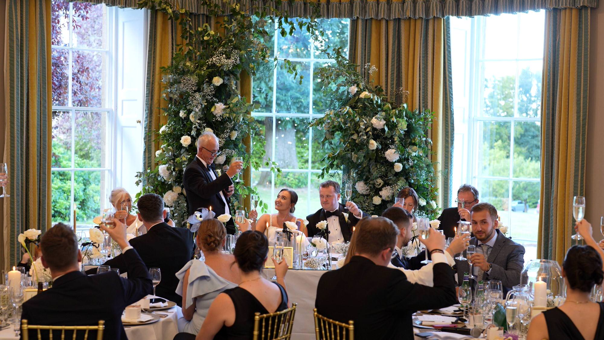 father of the bride toasts the couple at the top table at Rudding Park Harrogate