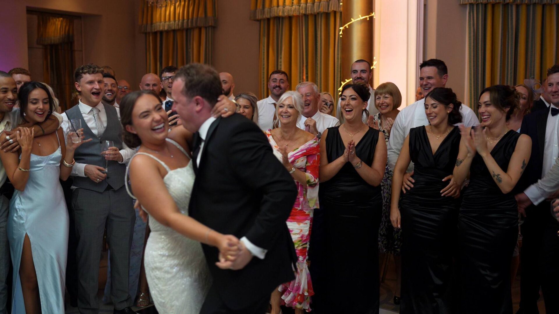 Guests in focus reacting to a fun first dance
