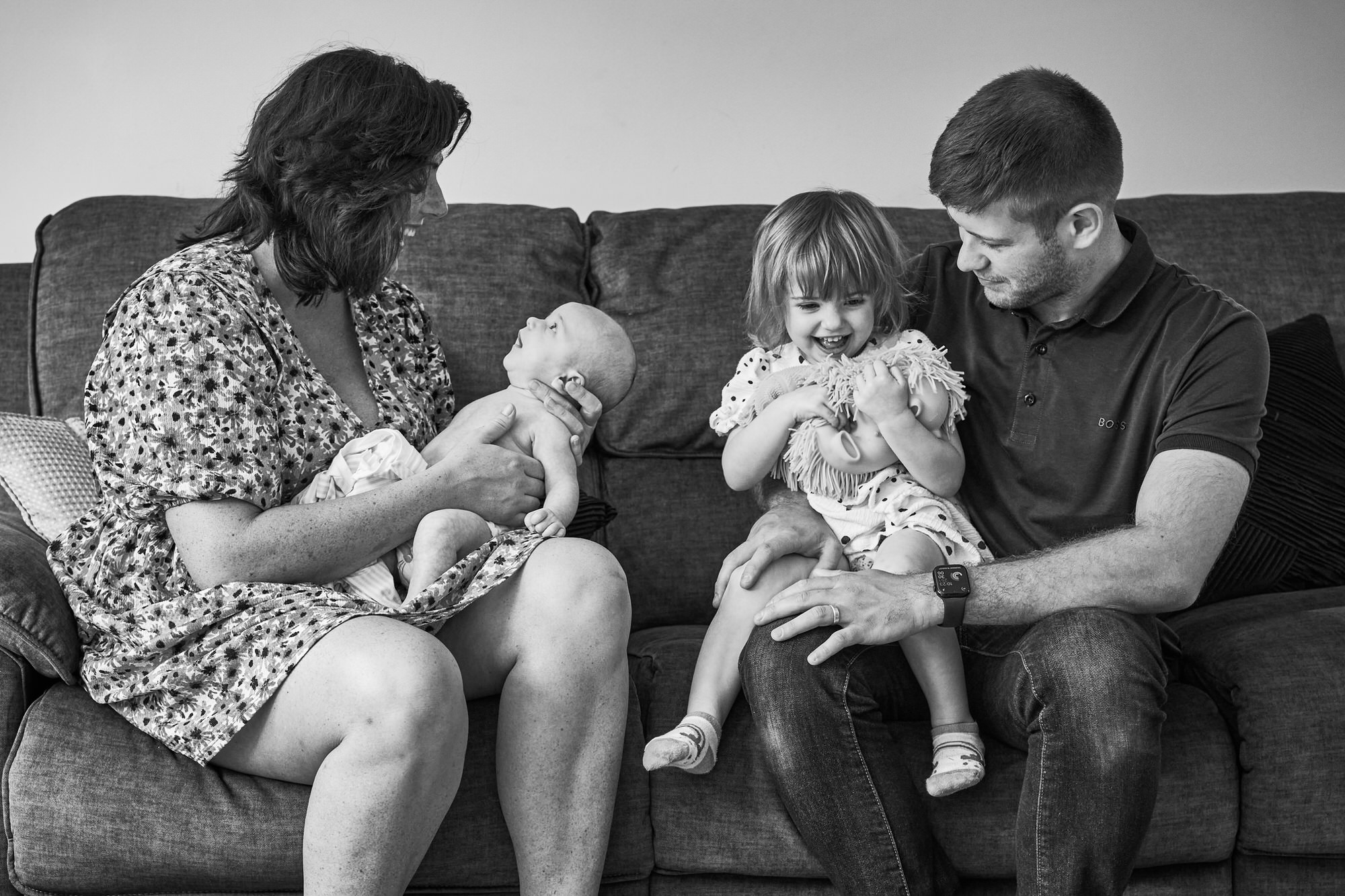 a family captured  naturally at home in their living room in Ormskirk